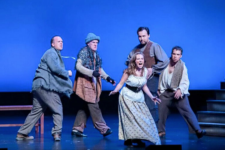 Lauren Mary Moore with cast on stage during Les Miserables